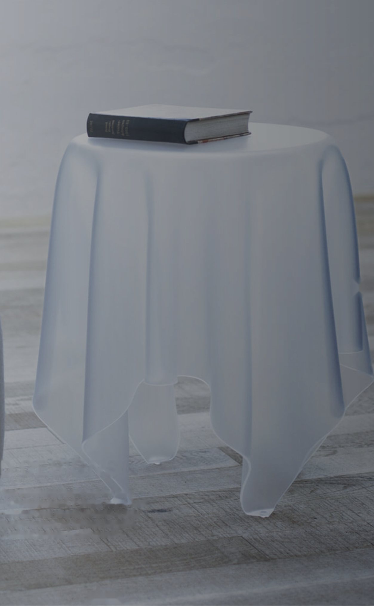 Frosted Illusion table with a book on top