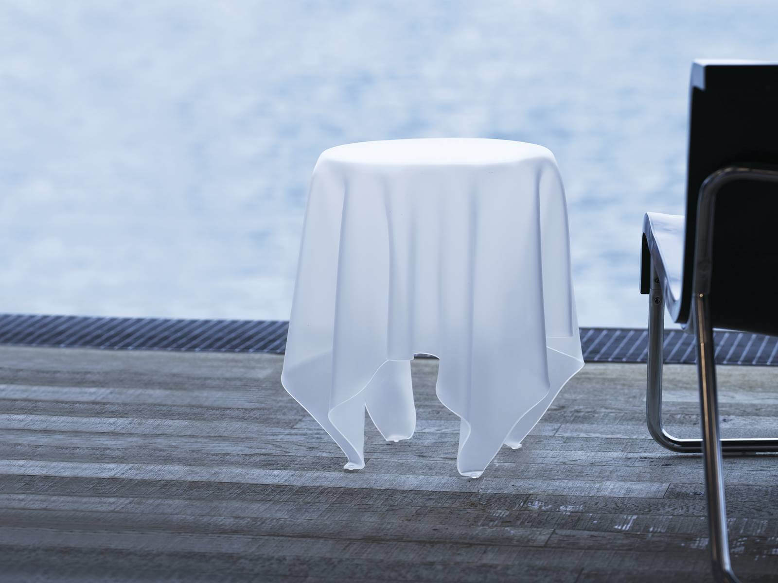 Illusion table on a wooden terrace by the sea